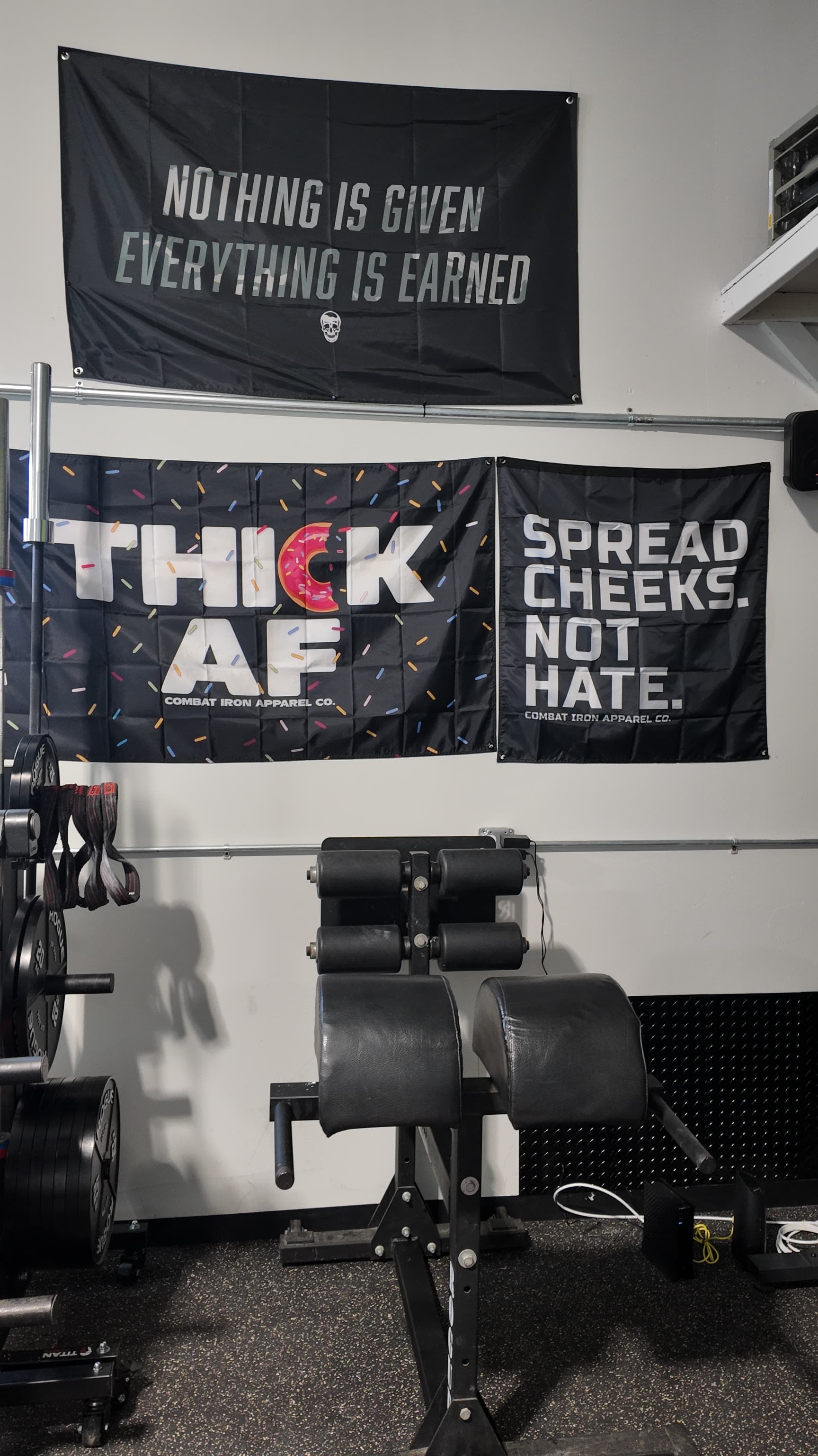 Glute ham developer on the rubber floor with strength banners on the wall behind