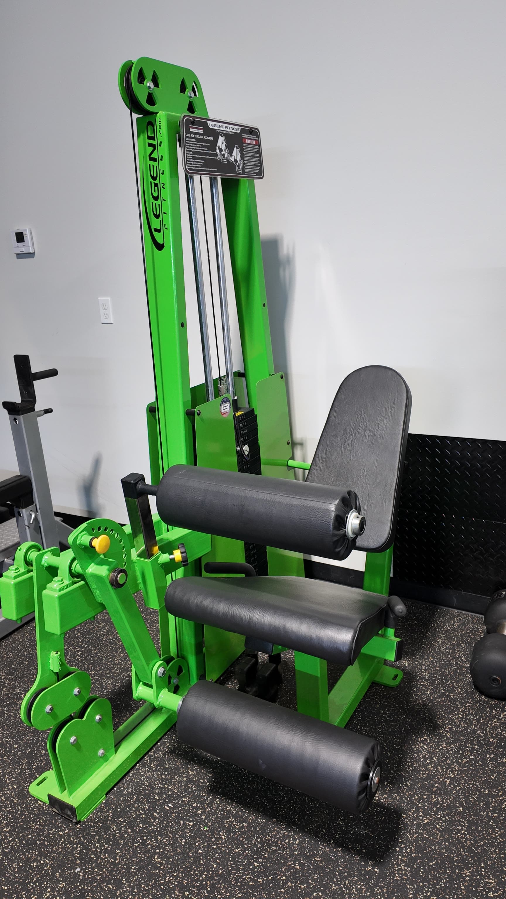 Green Legend Fitness leg extension and seated leg curl machine